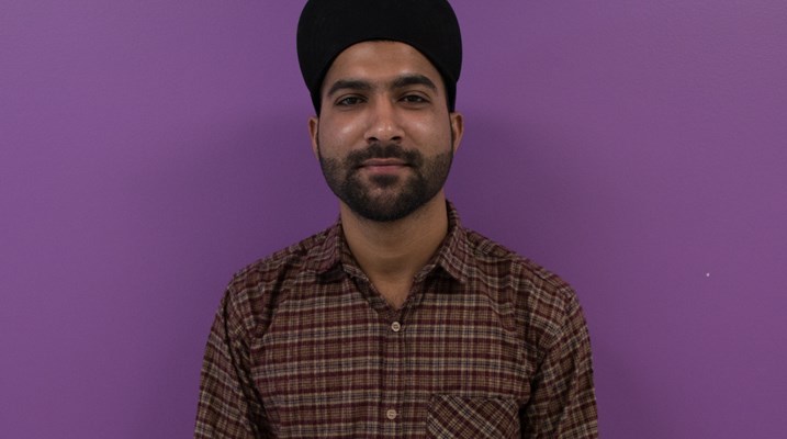 Student standing in front of a wall